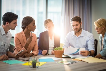Group of business people discussing at desk