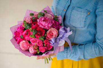 girl holding bouquet of a mixed pink and purple flowers