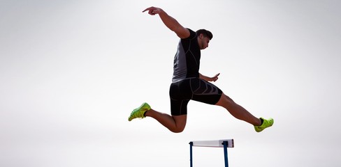 Athletic woman practicing show jumping