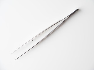 tweezers on a gray background