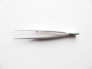 tweezers on a gray background