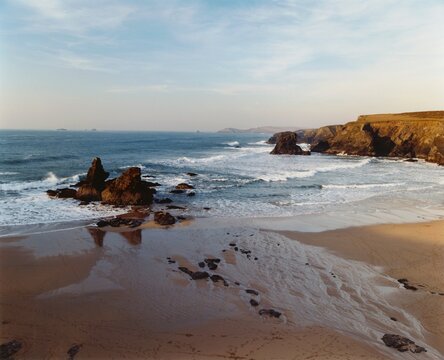 Beach at sunset, sea, surf and rocks