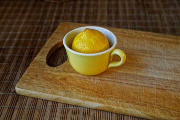 Lemon in a yellow cup.