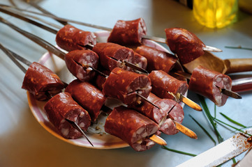 Sausages on a barbecue skewer.
