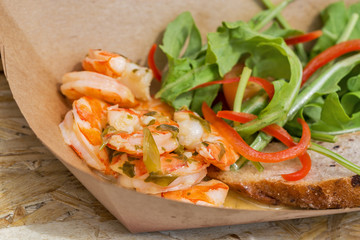 street food shrimps served with vegetables closeup