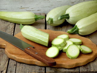 Fresh zucchini with squash on cutting board
