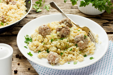 Bulgur with beef meat balls and spices in rustic style