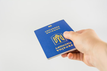 Hand with a passport of citizen of Ukraine on a white background