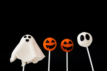 Halloween cake pops on black background

