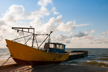 Yellow boat on the beach evening time