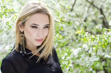 Fototapeta premium Beautiful girl in the flowered background