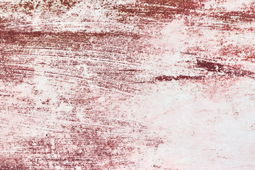 Deep red paint on the bottom of a boat worn off.
