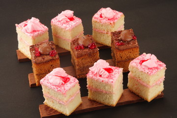 fresh chocolate  and strawberry cream cake in black background,.