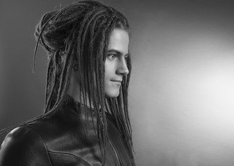 Young man's portrait. Stylish handsome sexy Guy with Dreadlocks