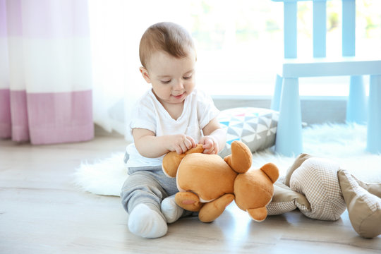 Cute baby boy with teddy bear