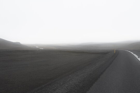 Grey road in empty landscape