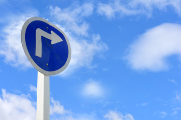 Turn right arrow sign on blue sky with cloud background for giving directions
