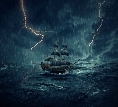 Vintage, old sailing ship lost in the ocean in a rainy, stormy night with lightnings in the sky. Adventure and journey concept	