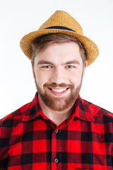 Close-up portrait of a smiling bearded man in hat
