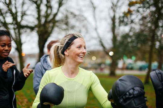 Female Boxers Wearing Boxing Gloves Training In Park