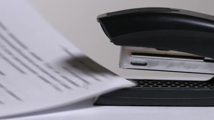 Close up of stapler, stapling sheets of paper 2