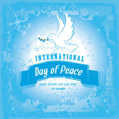 Peace dove with olive branch for International Peace Day poster on a blue grungy effect
