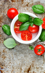 Cherry tomatoes and fresh green basil - traditional ingredients