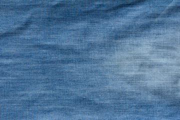 Closed up of blue creased denim jeans texture