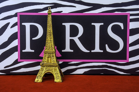 Fototapeta Paris France sign with black and white zebra stripes and gold Eiffel tower ornament on red background
