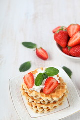 Delicious waffles with strawberries and mint