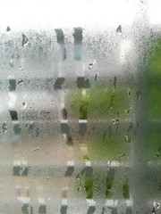 Fototapeta na wymiar Water drop on bedroom window in morning