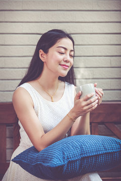 Beautiful asian woman enjoys fresh coffee in the morning. Happy time.