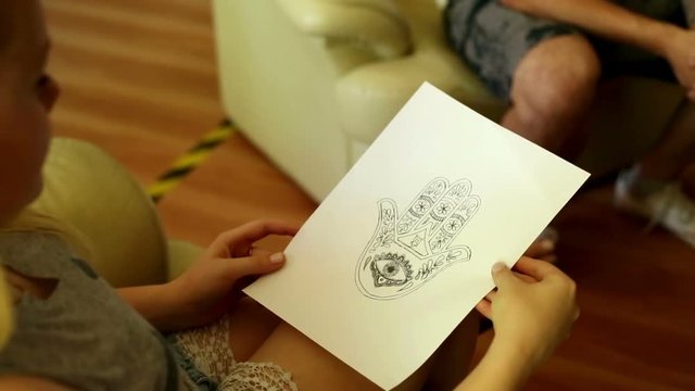 Woman consults on tattoo in the studio tattoo
