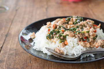Thai food, rice topped with stir-fried pork and basil.