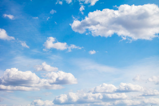 Blue sky with light cumulus clouds.