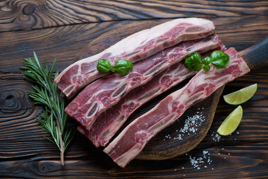 Raw fresh short beef ribs for grill, rustic wooden setting