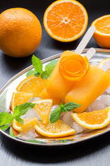 Orange fruit sorbet ice cream popsicles.