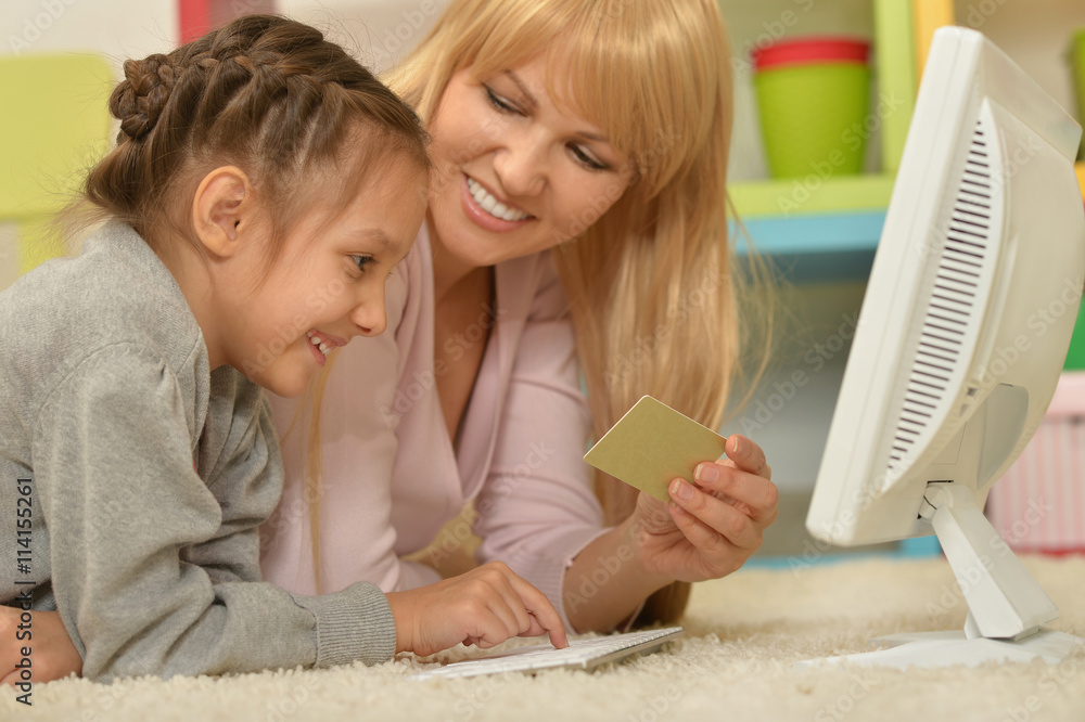 Poster girl with mother doing shopping online