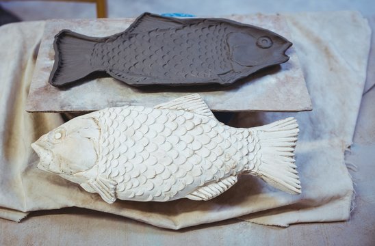 High angle view of clay fishes