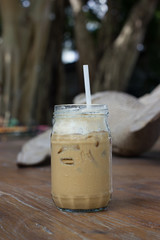 Iced coffee with milk is on the table.