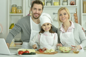Obraz na płótnie Canvas happy family cooking in kitchen