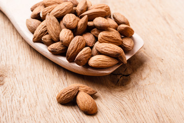 Almonds on wooden spoon