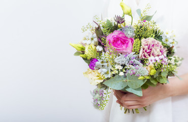 Beautiful colorful wedding bouquet in a hand of a bride