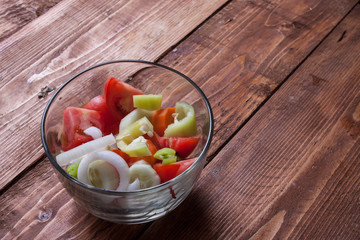 bowl of fresh vegetable salad on wooden table