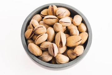 bowl of pistachios on white background