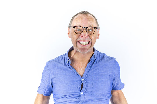 Portrait of angry and furious man with glasses in tight blue shirt. 