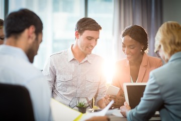 Group of business people interacting at desk