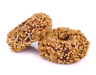 A pair of peanut covered donuts over white.