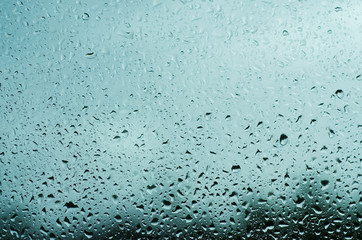 Rainy wet cold blue sky eco seasonal natural background with water drops