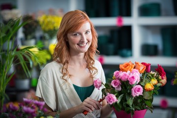 Female florist preparing flower bouquet